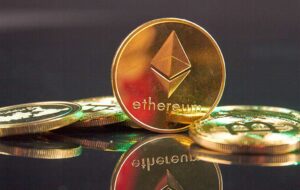 Golden Ethereum Cryptocurrency Coin on the Reflective Surface
